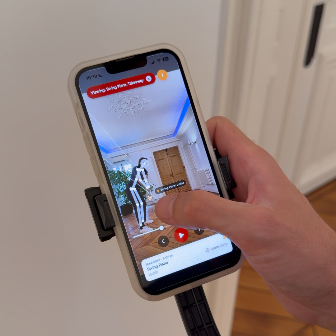 Phone on the tripod filming a swing at home for the Goose Golf app