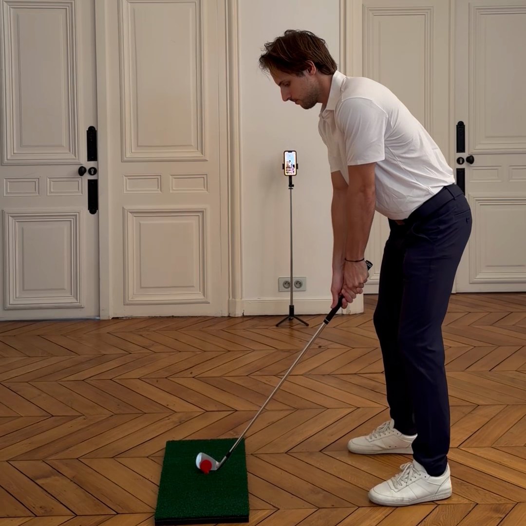 Full swing at home on the Learn Golf at Home mat, phone on the tripod filming