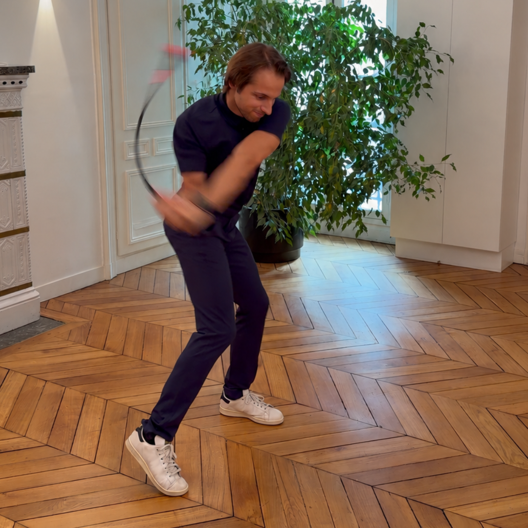 Golfer taking a full swing at home with the Swing Trainer